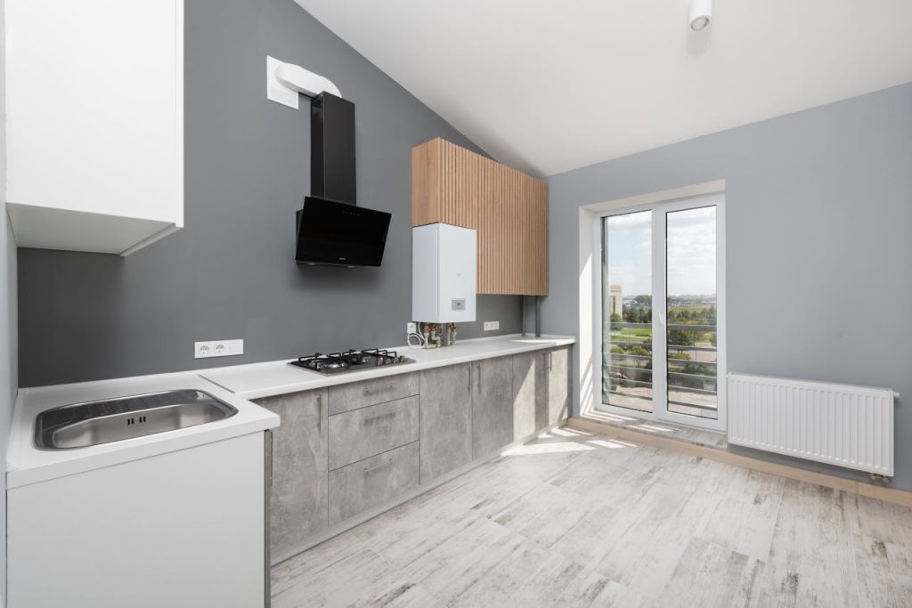 Modern remodeled kitchen with wood cabinetry and a small television