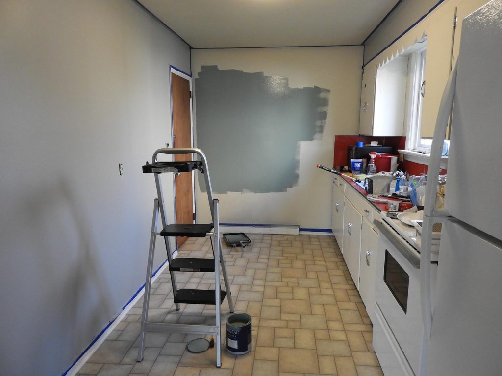 Remodel workspace with paint supplies and a ladder